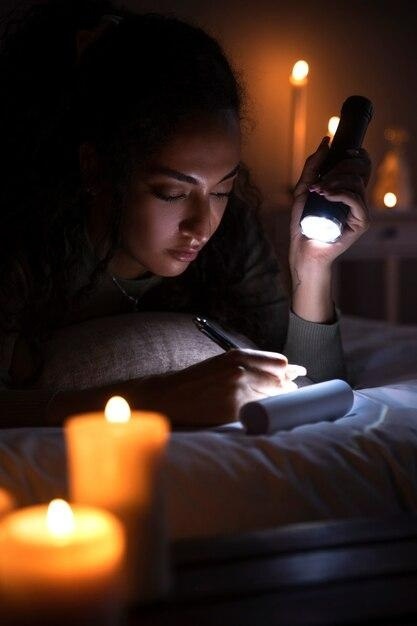 Free photo side view woman writing in bed